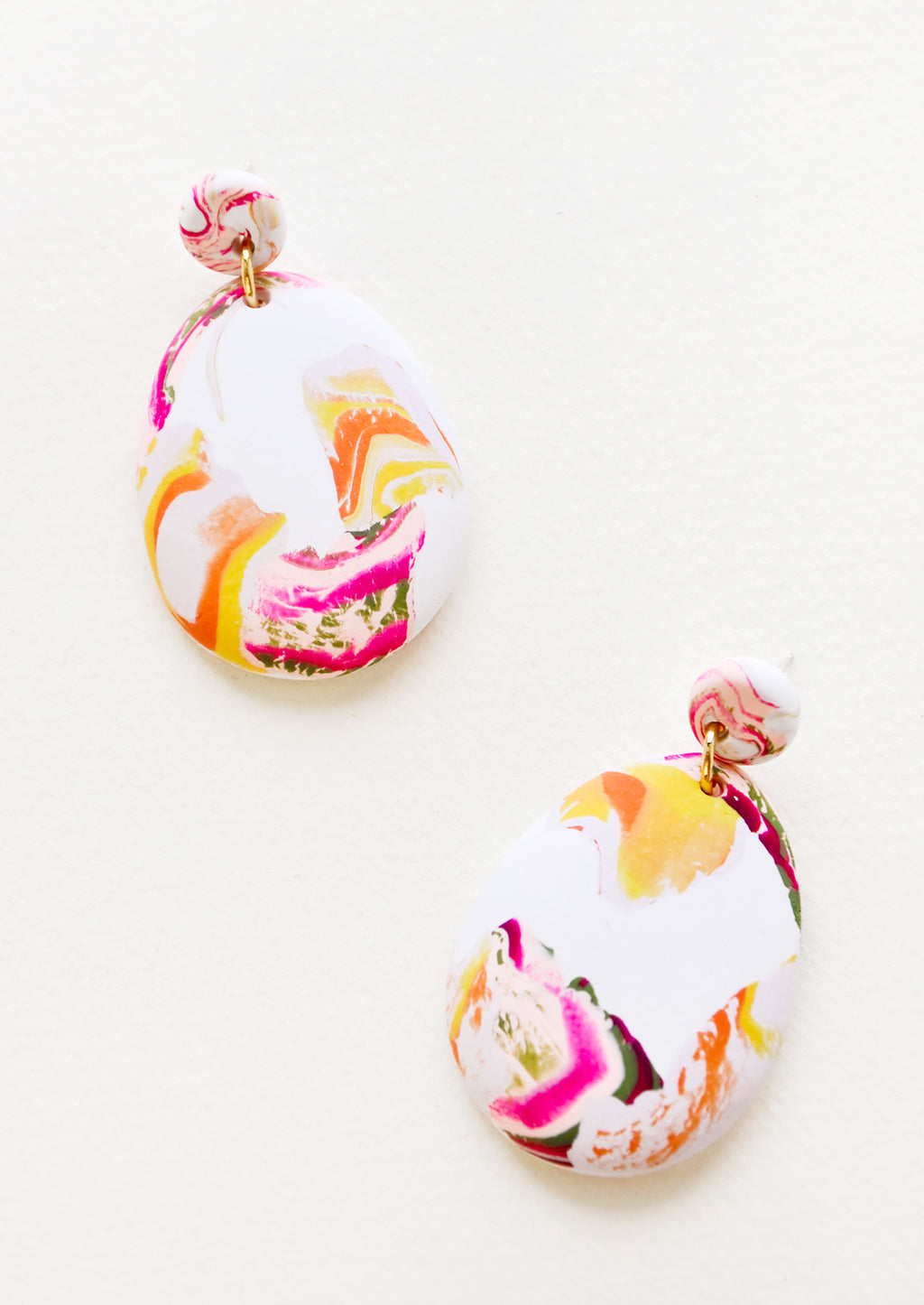 Sea Smoke: Pink, yellow, orange and white marbled clay earrings, with a larger oval dangling from a small circle.