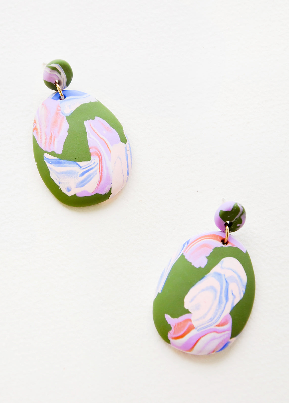 Pink, blue and green marbled clay earrings, with a larger oval dangling from a small circle.