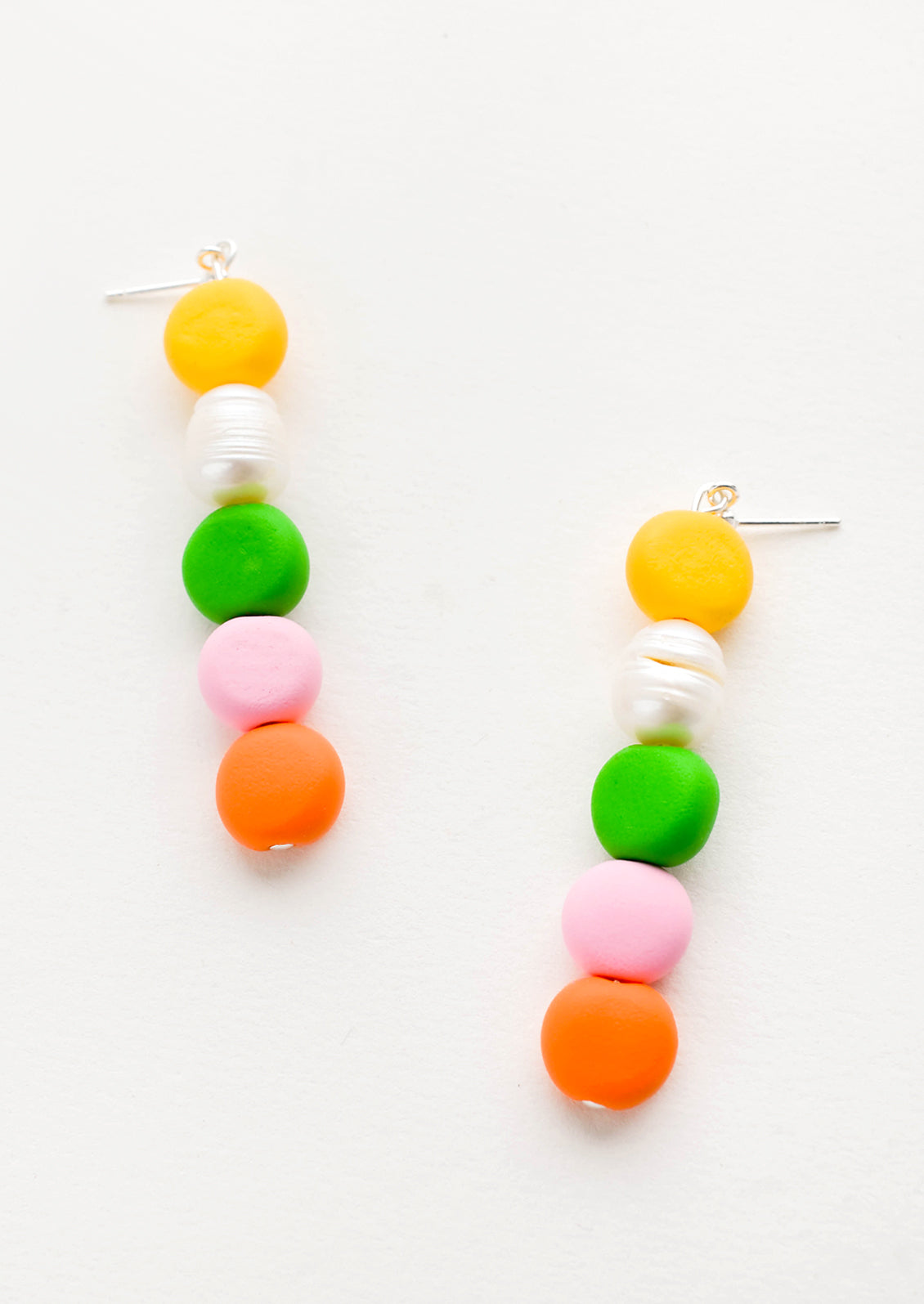Earrings with colorful clay beads stacked in a row mixed with one pearl bead