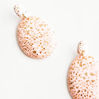 Blush / White: Dangling glitter covered earrings, with a blush pink larger oval dangling from a small white bead.