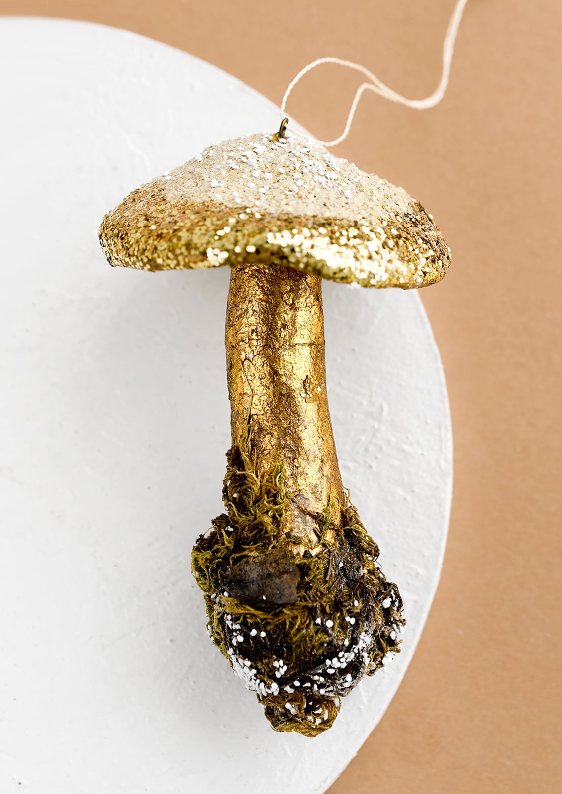 A holiday ornament of double mushroom in gold.