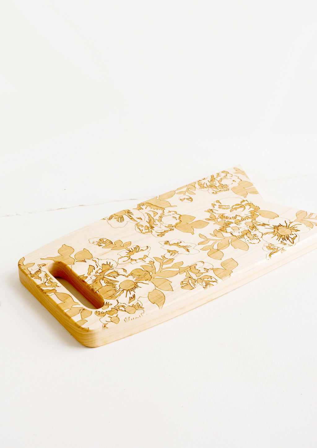 2: Flag shaped maplewood cutting board with handle cutout, lasercut floral pattern