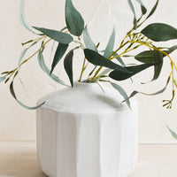 1: A short and wide ceramic vase with narrow opening, with softly fluted design.
