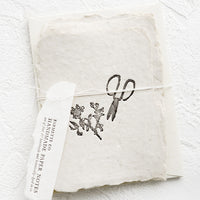 2: A packaged set of cards made from handmade paper with a letterpress printed image of garden shears.