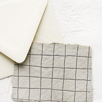 2: A greeting card made from handmade paper with a letterpress printed grid pattern.