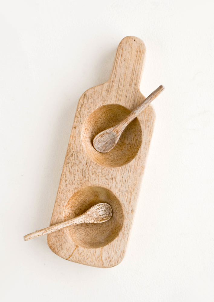 Paddle-shaped wooden server with two concave "bowls" and small spice spoons