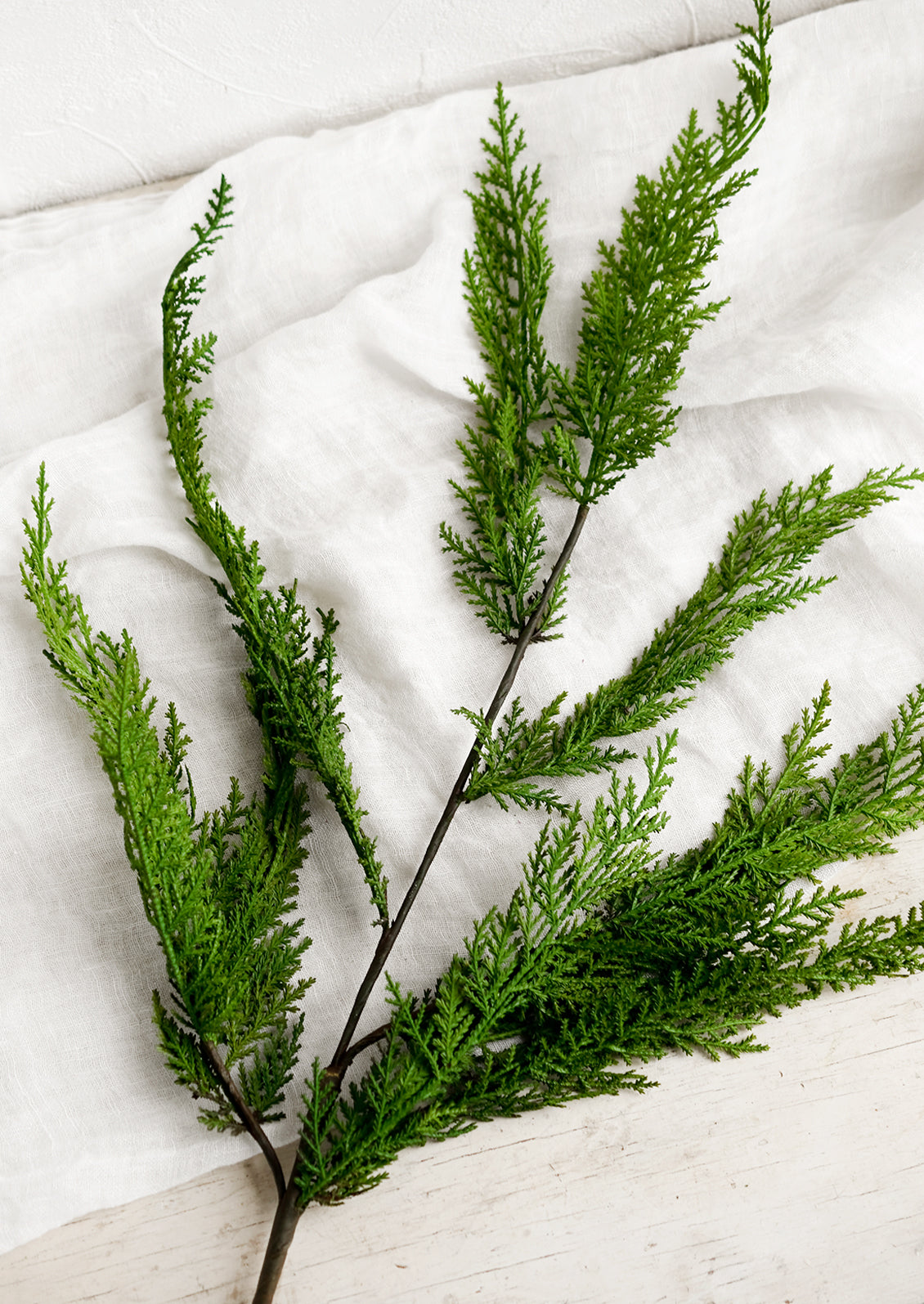 A green faux cedar spray.