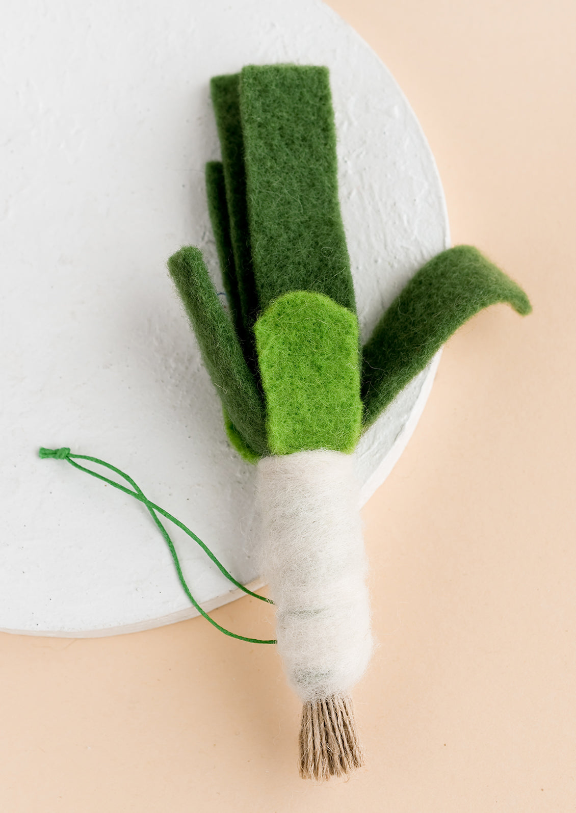A felted ornament of a leek.