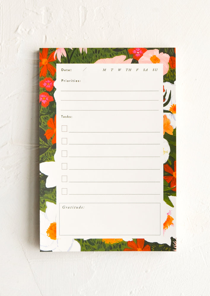 A notepad with days of the week, priorities, tasks, and gratitude.