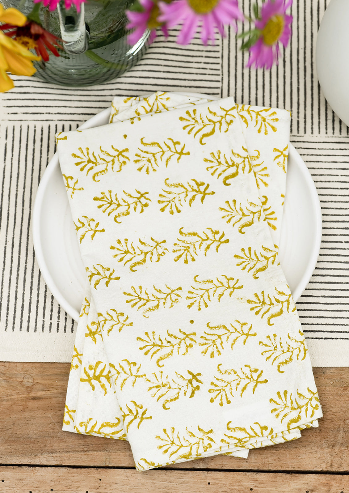 A pair of block printed cotton napkins on a table.
