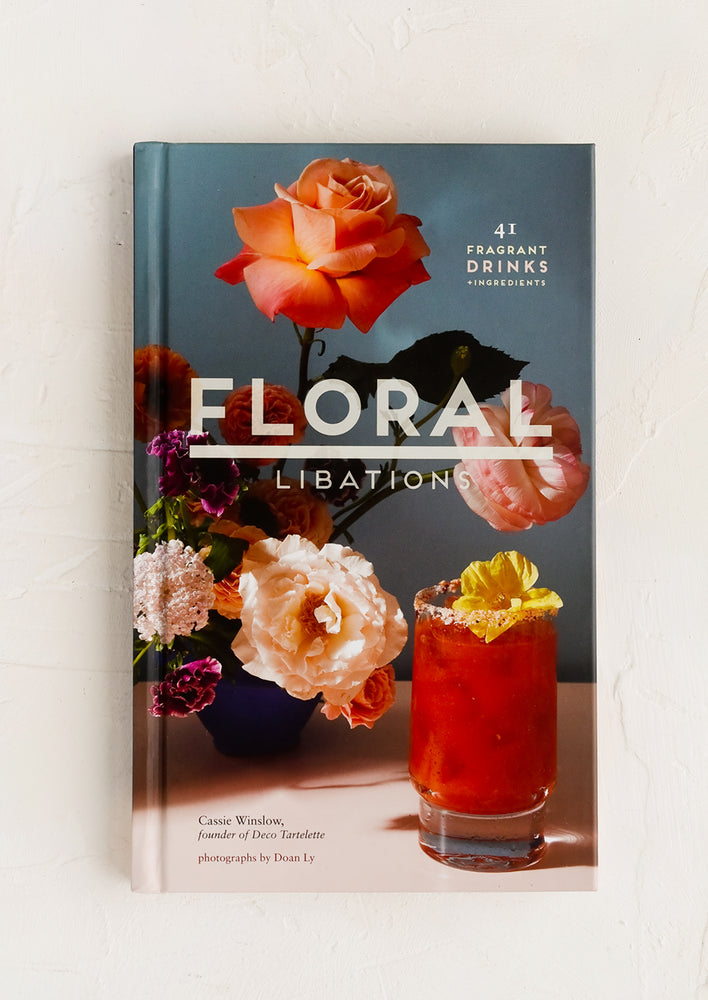 1: A hardcover recipe book, cover featuring vase of flowers next to bloody mary drink.