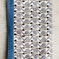 Dusty Blue Multi: A tea towel with dusty blue print and trim.