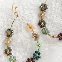 Cool Multi: A pair of gold teardrop wire earrings with cool hued floral beading.