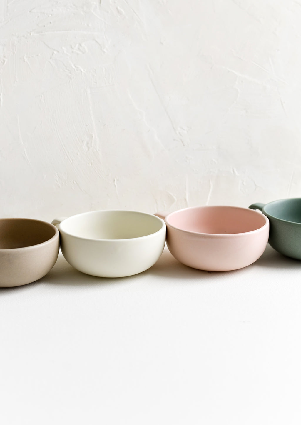 4: Assorted colors of ceramic mug bowls.