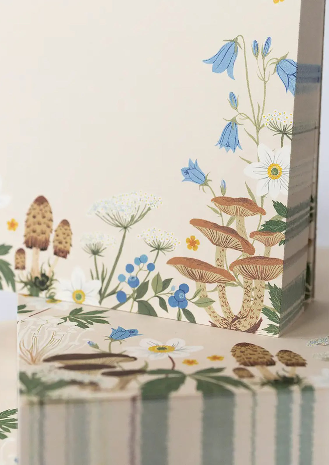 A chunky square notepad reading "MEMO" at top with mushroom floral print at bottom.