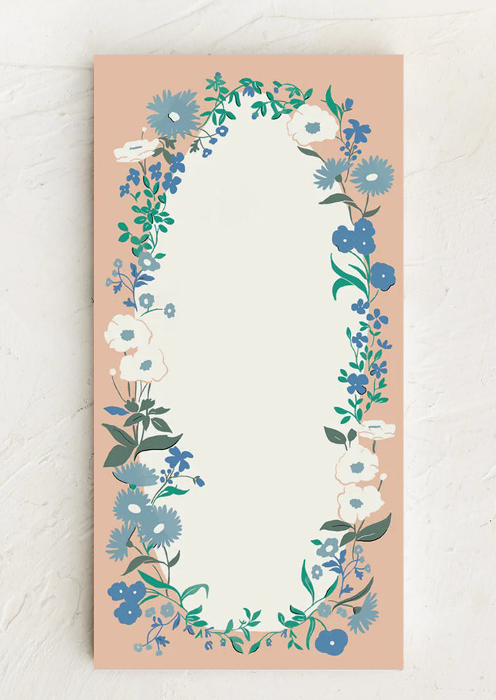 A pink, blue and white floral print notepad.