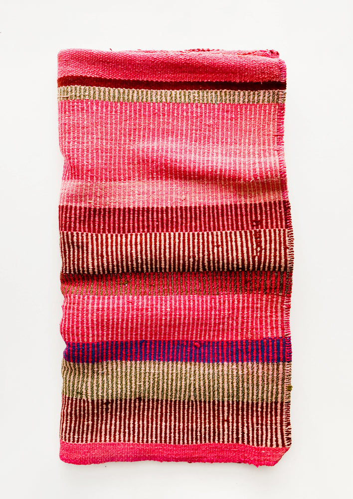 Vintage wool textile in striped pattern in a mix of pink, tan and purple