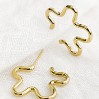 2: A pair of gold flower outline earrings.