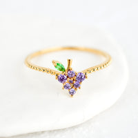 Grape / Size 5: A gold ring with beaded texture and grape shaped crystal front.