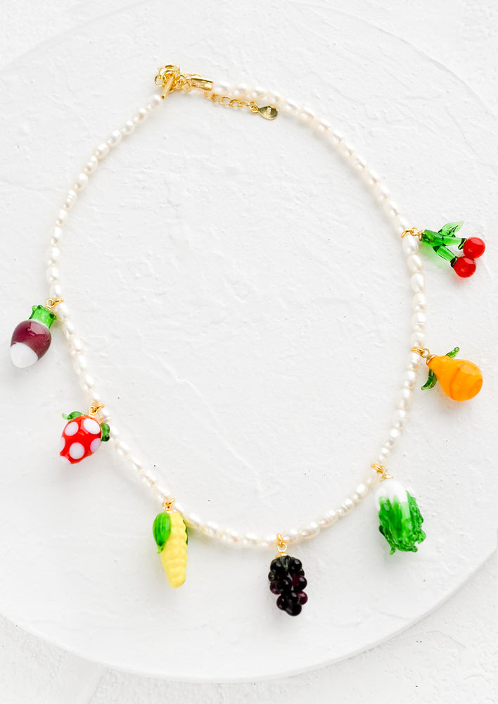 1: A pearl necklace with glass fruit and veggie charms.