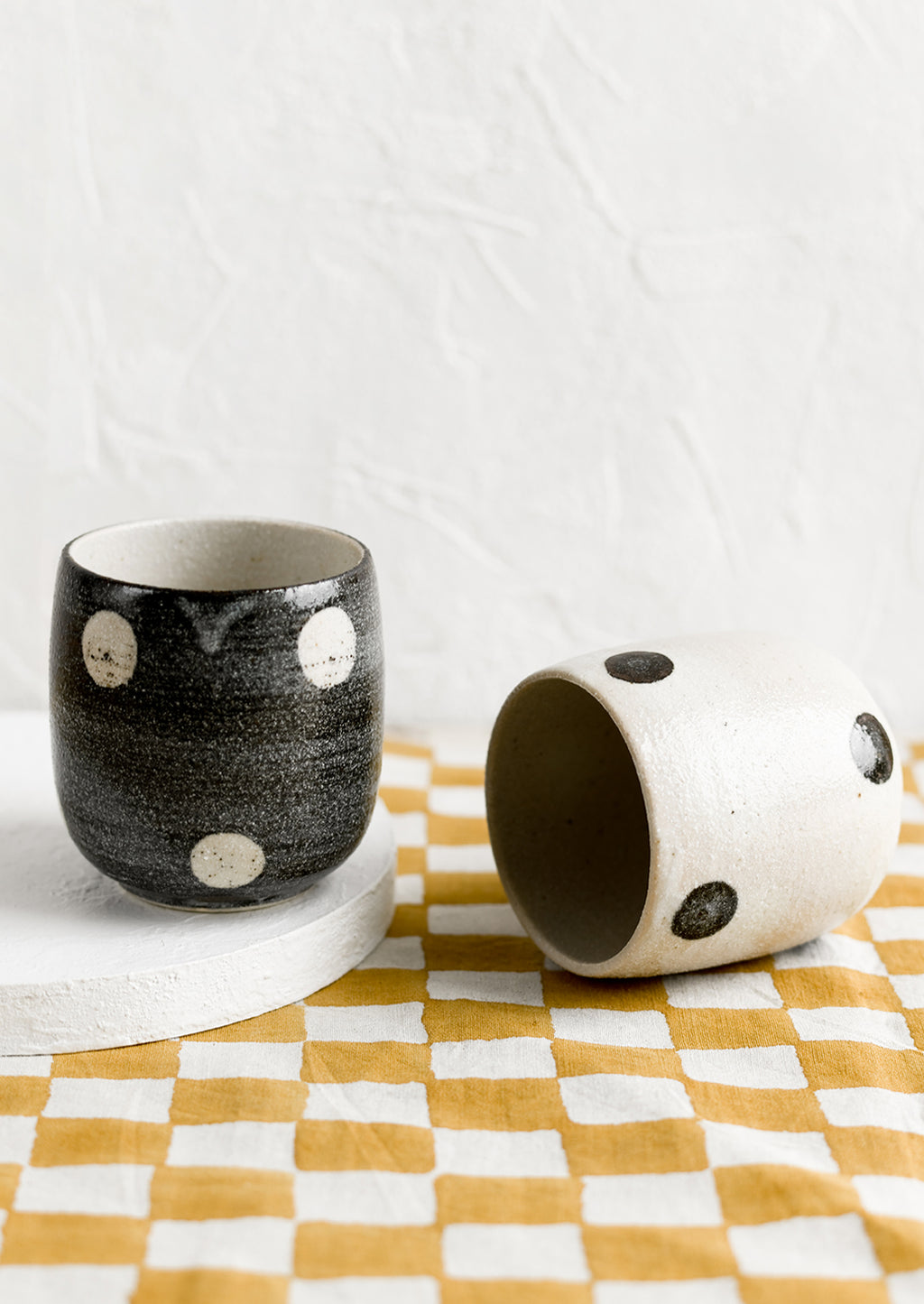 3: Black and white cups with contrasting polka dot patterns.