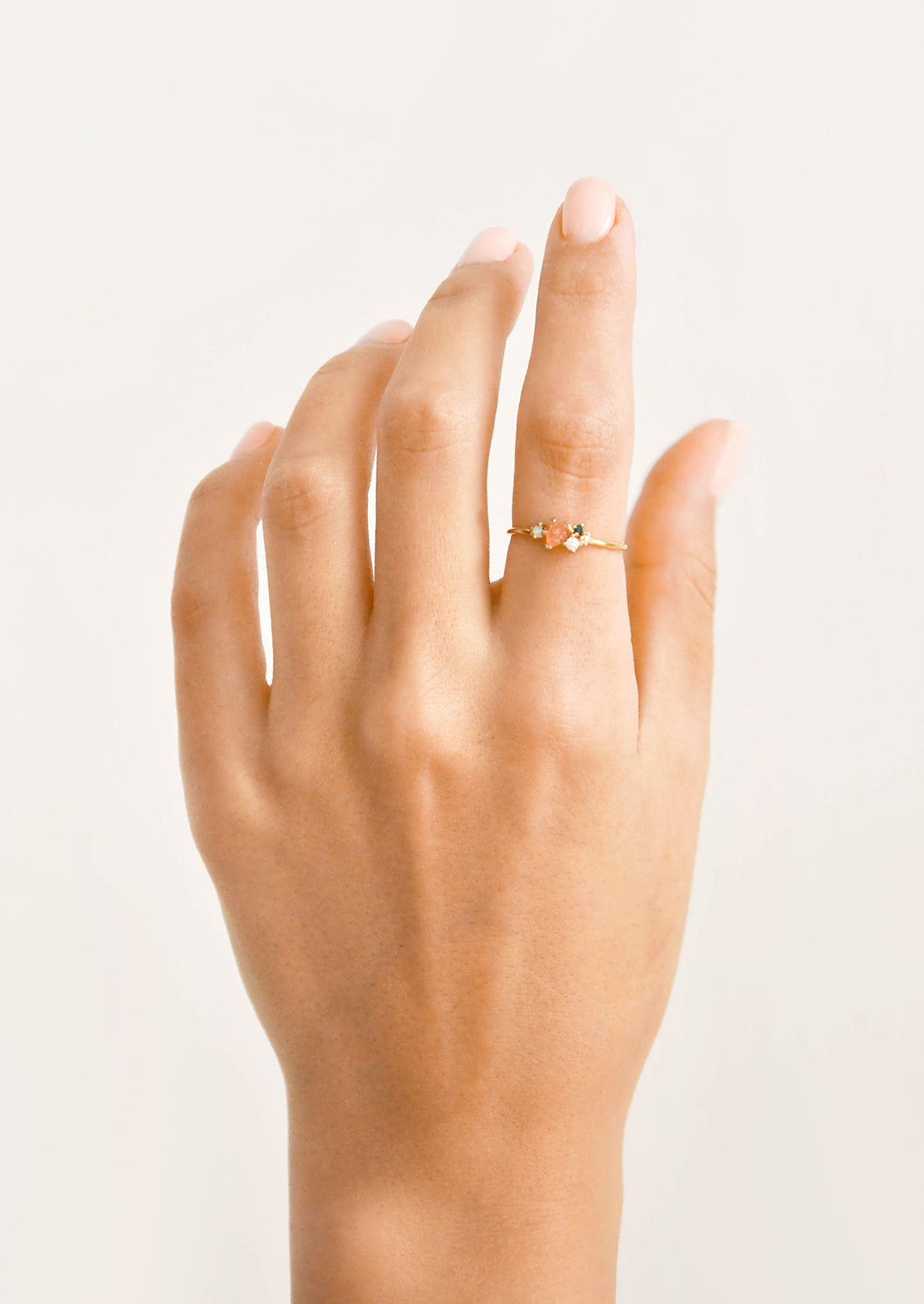 Model shot of hand wearing slim gold ring.