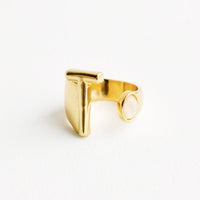 T: Yellow gold ring with letter T and oval glass crystal, and wide adjustable band.