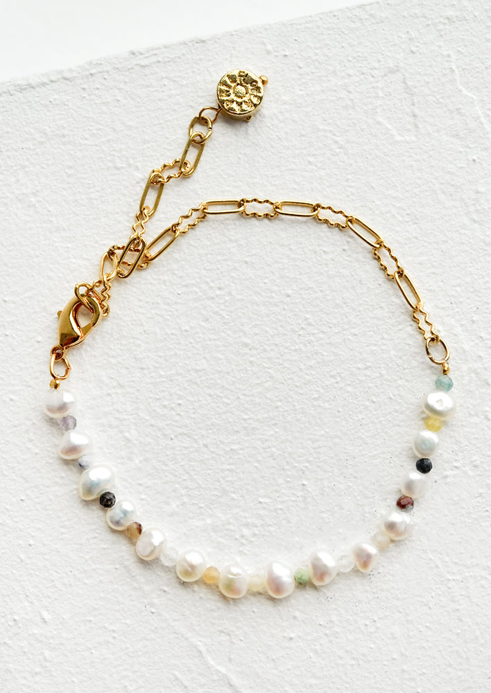 1: A bracelet with alternating pearl and gemstone beads on gold chain.