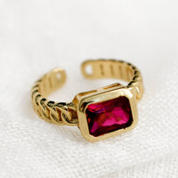 One Size / Ruby: A gemstone ring with heavy chainlink band and rectangular ruby baguette.