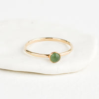 Aventurine / Size 5: Thin gold ring with bezel set green stone.