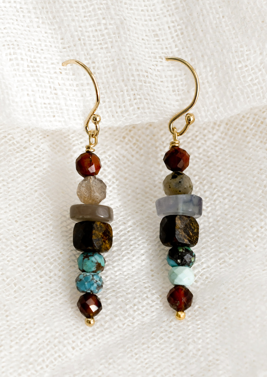 Garnet Multi: A pair of multicolor beaded mixed garnet gemstone earrings in a straight line.