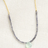 Iolite / Blue Chalcedony: A beaded necklace with small iolite beads and blue chalcedony teardrop.