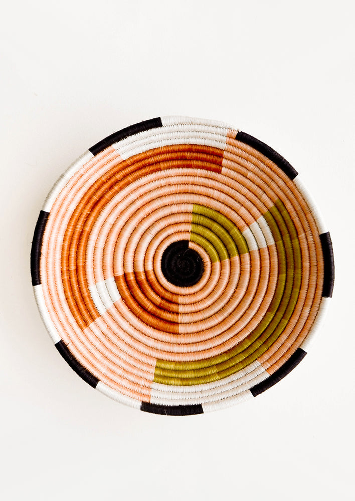 1: Round bowl made from woven sweetgrass, dyed in earthy colors with geometric pattern