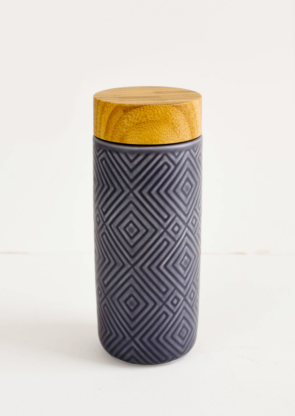 Stone Blue: Geometric textured ceramic tall travel tumbler in stone blue with bamboo lid