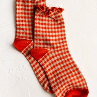 Tomato Red: A pair of red gingham patterned socks with ankle ruffle.