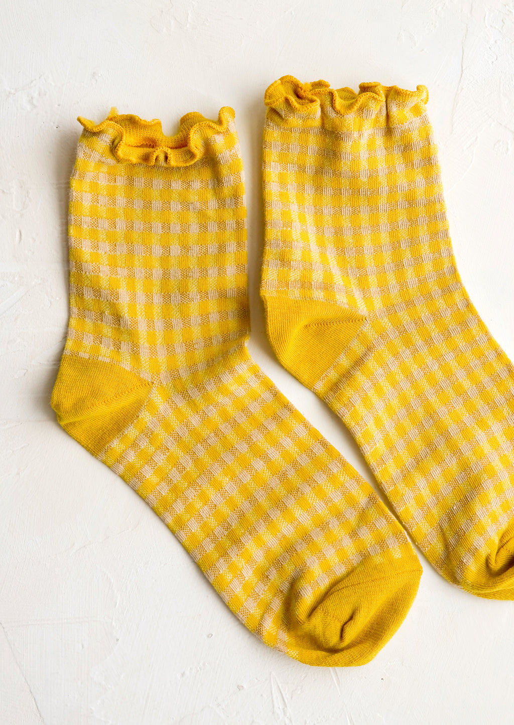Lemon Yellow: A pair of yellow gingham patterned socks with ankle ruffle.
