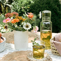 2: A table setting with mint tea in glass decanter.
