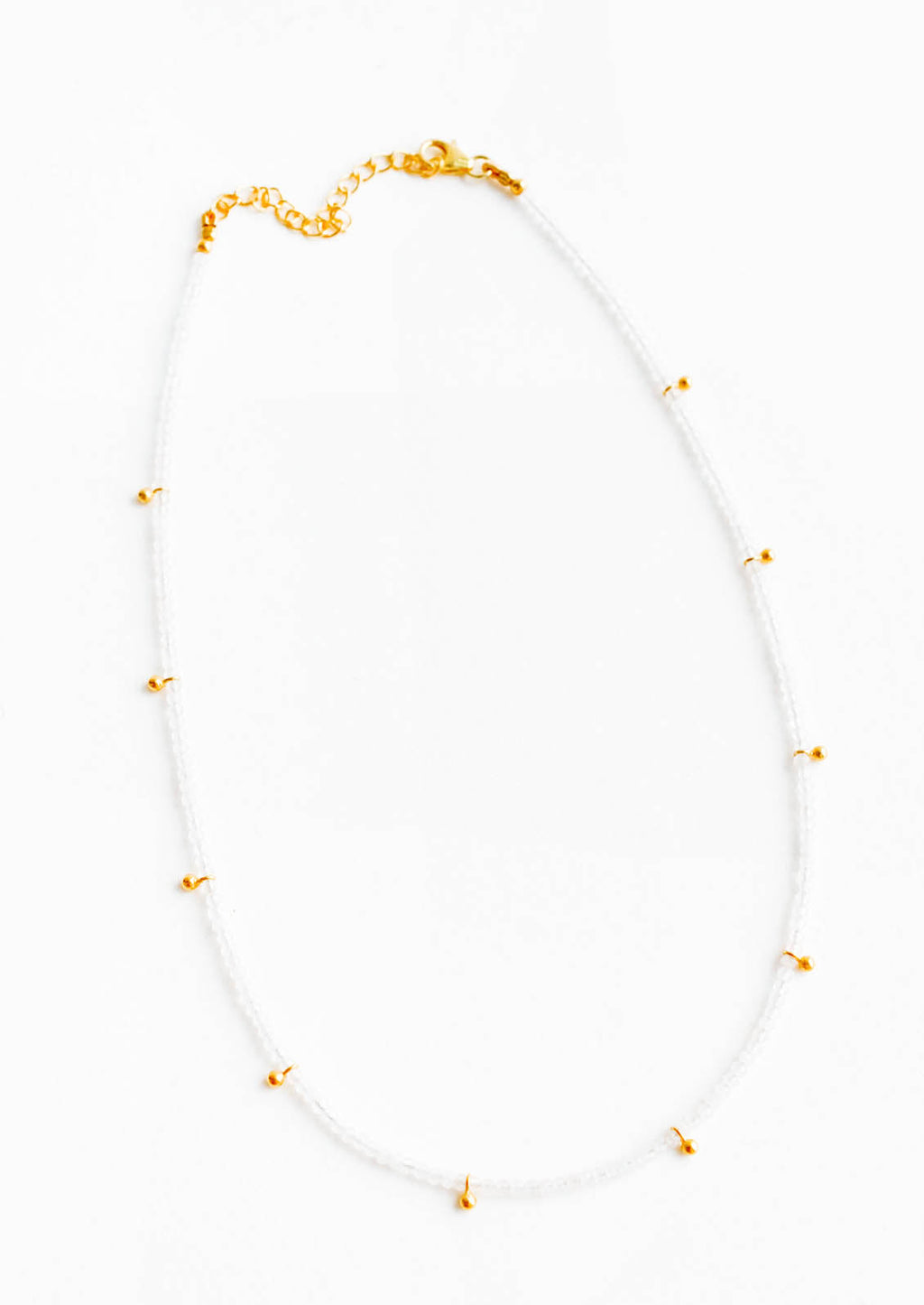 Moonstone: A necklace of clear gray gemstones with evenly spaced gold beads and a golden chain clasp.
