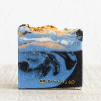 Closer: A bar of soap in blue, gold and black.