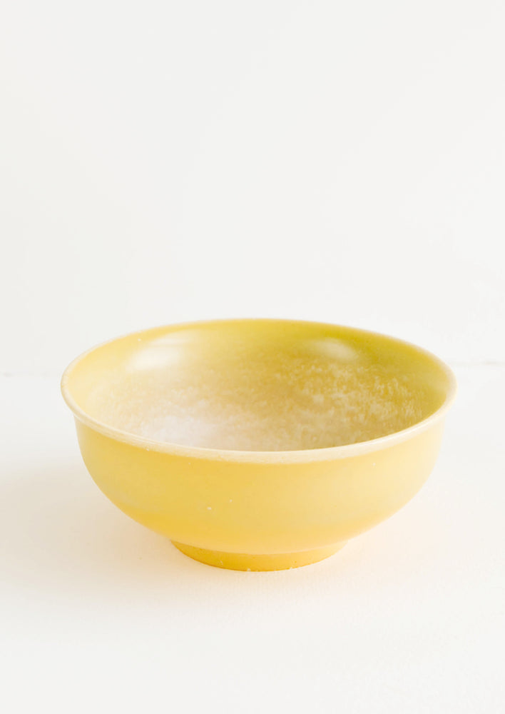 1: Round Yellow Ceramic Bowl with patina-like finish on its interior.