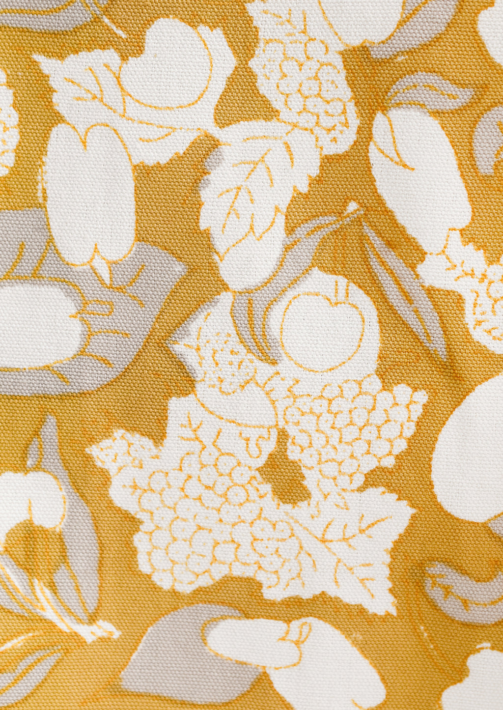 4: A gold, grey and white fruit print tea towel.