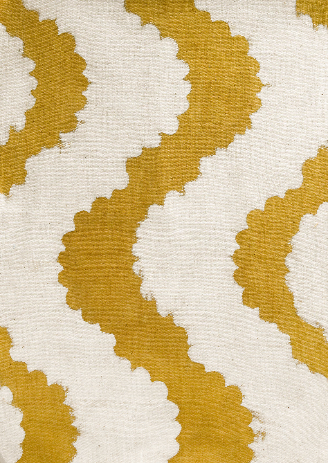 A mustard table runner with wavy pattern.