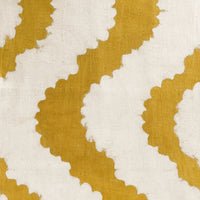 2: A mustard table runner with wavy pattern.