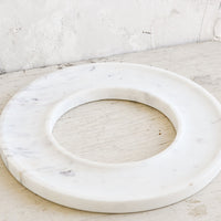 1: A circular white marble tray with an empty center.