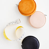Mustard Suede: Product shot featuring multiple styles of leather covered tape measures.