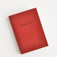 Karaoke Songs / Rust: Mini red notebook featuring text "Karaoke Songs".