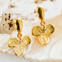 2: A pair of gold post back earrings in grape leaf shape.