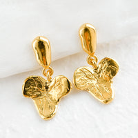1: A pair of gold post back earrings in grape leaf shape.