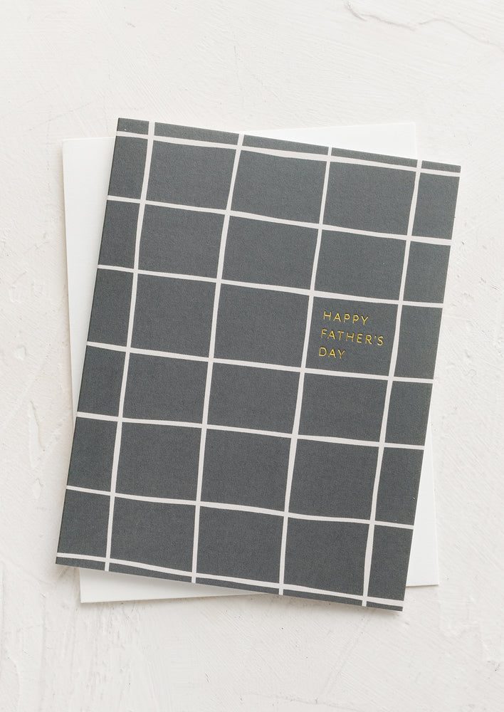 A greeting card with grey grid pattern reading "Happy Father's Day".