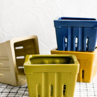 1: Ceramic berry baskets in blues, greens and yellows.